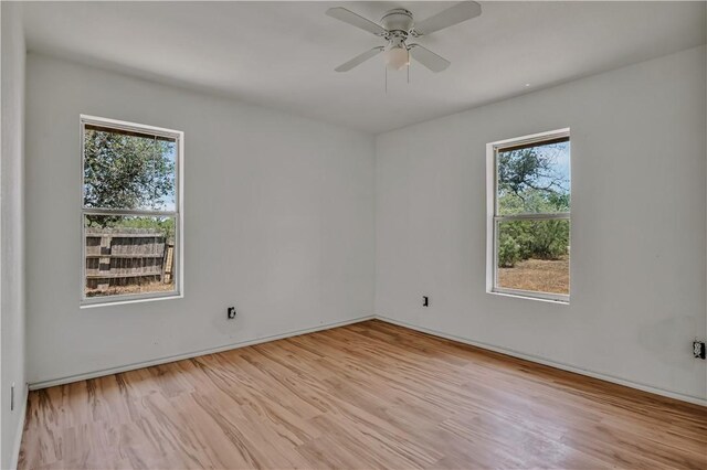5367 Paloma Trl, Robstown, TX 78380 - empty room featuring plenty of natural light, a ceiling fan, and light wood-style flooring