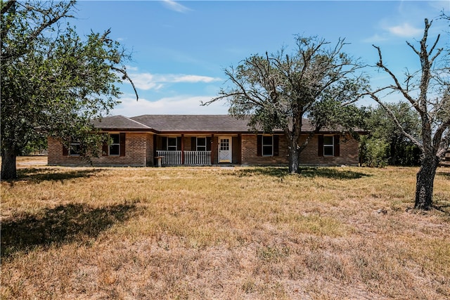 5367 Paloma Trl, Robstown, TX 78380 - ranch-style house with a porch, brick siding, and a front lawn