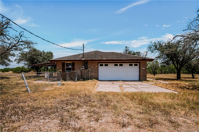 5367 Paloma Trl, Robstown, TX 78380 - view of front of home with concrete driveway, a garage, and brick siding