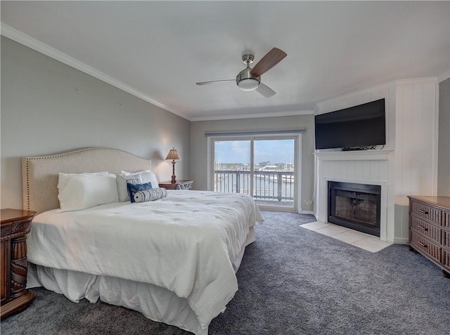 bedroom with access to exterior, crown molding, light colored carpet, a fireplace with flush hearth, and a ceiling fan