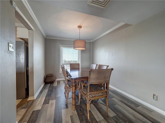 dining space with baseboards, dark wood-style flooring, and crown molding