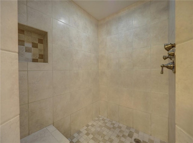 bathroom with a tile shower