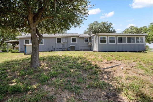 back of property with cooling unit and a yard