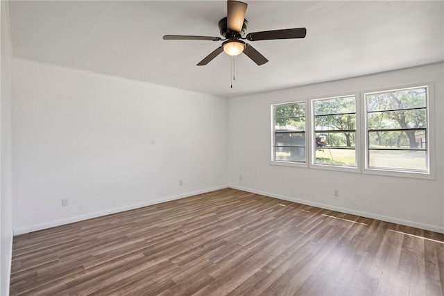 unfurnished room with a wealth of natural light, hardwood / wood-style flooring, and ceiling fan