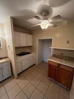 639 N Commercial St, Aransas Pass, TX 78336 - kitchen featuring light tile patterned flooring, white cabinets, light countertops, and a ceiling fan