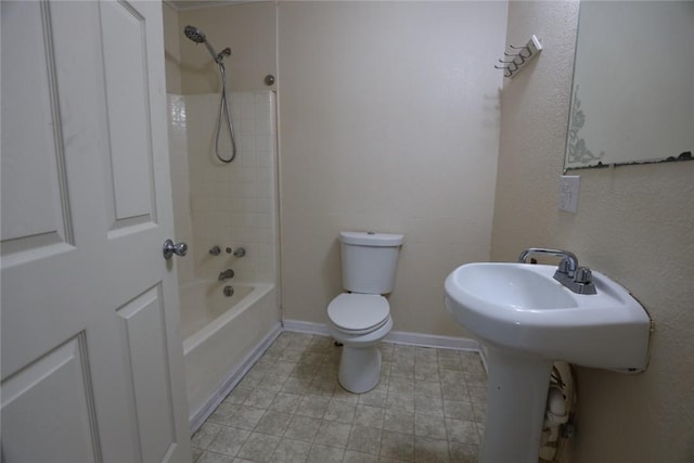 639 N Commercial St, Aransas Pass, TX 78336 - bathroom with toilet, shower / bathing tub combination, and baseboards