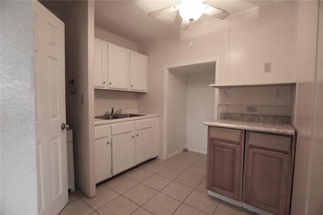 639 N Commercial St, Aransas Pass, TX 78336 - kitchen with a sink, light countertops, white cabinets, and ceiling fan