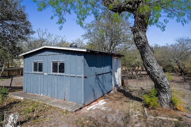 view of shed featuring fence