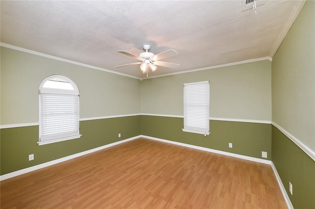 unfurnished room featuring visible vents, a textured ceiling, wood finished floors, and a ceiling fan