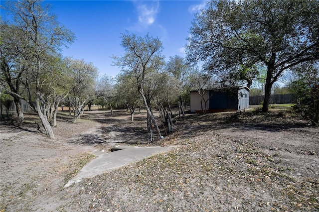 view of yard with an outbuilding and fence