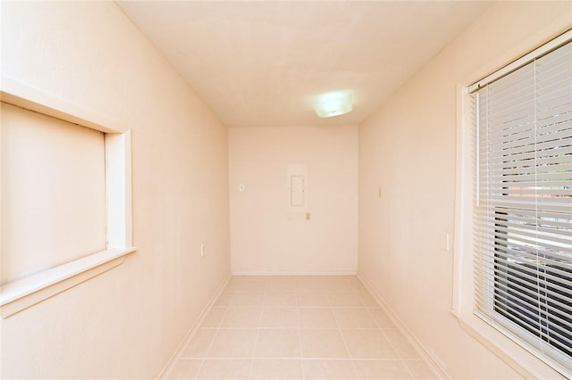 interior space featuring light tile patterned flooring and baseboards