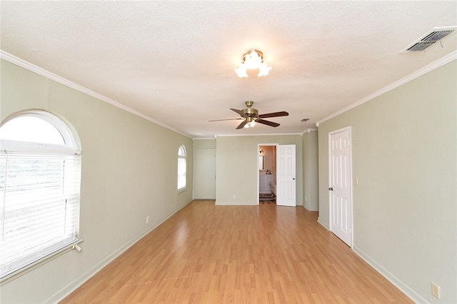 unfurnished room featuring baseboards, visible vents, ceiling fan, light wood-style floors, and a textured ceiling