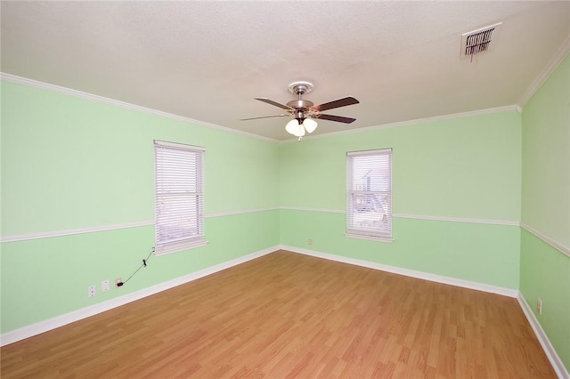 unfurnished room with baseboards, wood finished floors, and ornamental molding