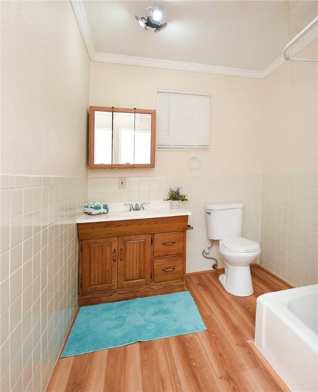 full bathroom with tile walls, toilet, wood finished floors, and ornamental molding