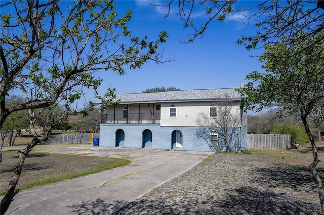 exterior space featuring a balcony and fence