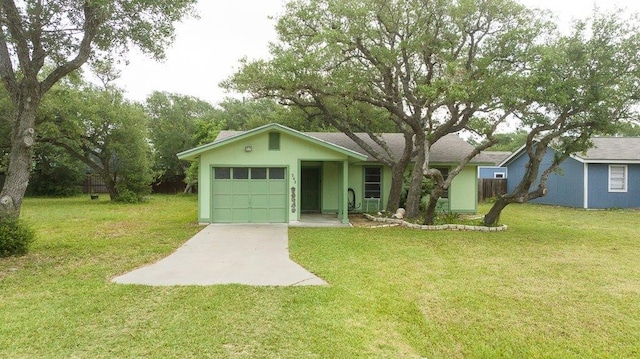 ranch-style house with a garage, concrete driveway, and a front lawn