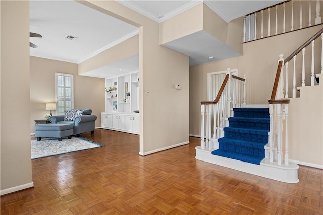 foyer entrance with crown molding, parquet floors, and ceiling fan