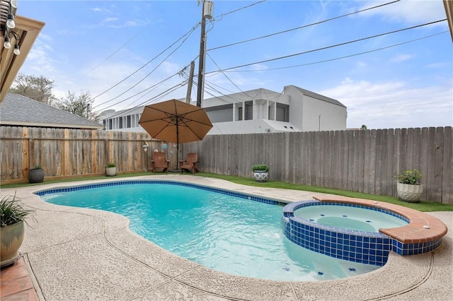 view of swimming pool with an in ground hot tub