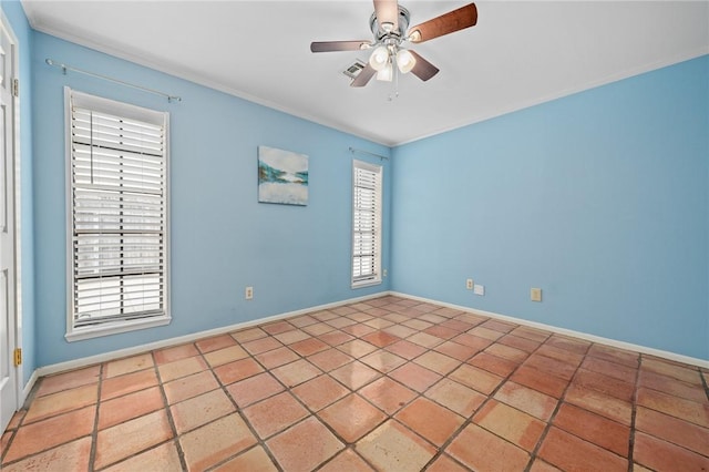 spare room featuring plenty of natural light, ornamental molding, and ceiling fan