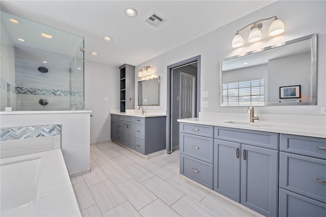 bathroom featuring vanity and tiled shower