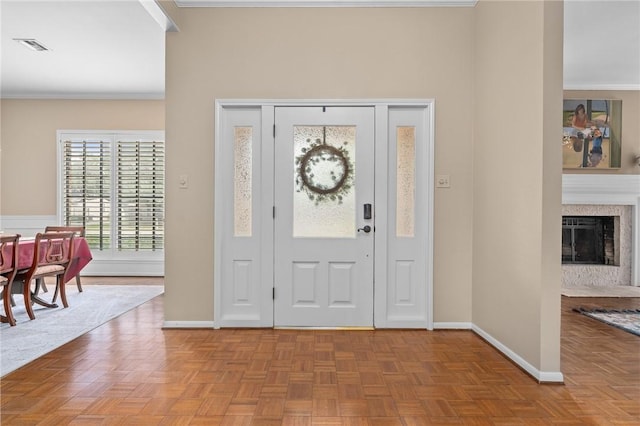 foyer featuring light parquet flooring and ornamental molding