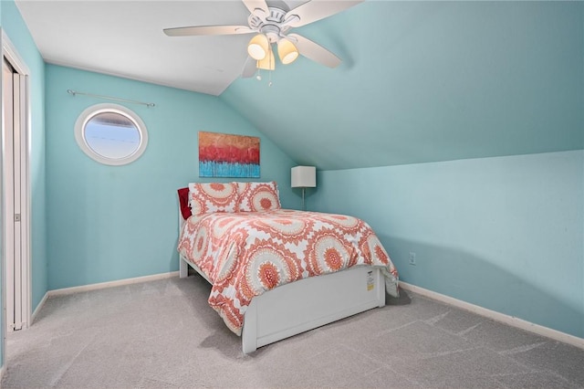 bedroom featuring light carpet, vaulted ceiling, and ceiling fan