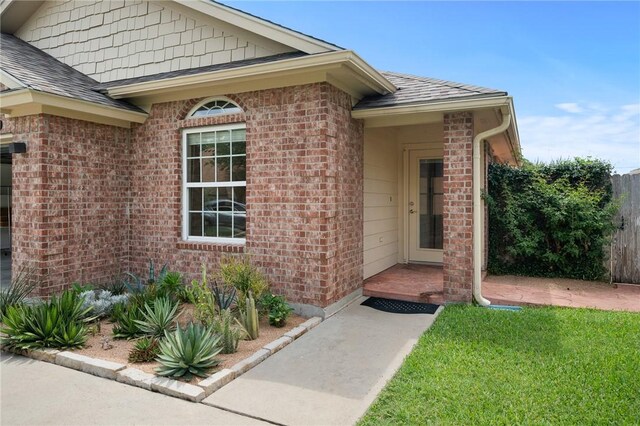 139 Heron Oaks St, Rockport, TX 78382 - entrance to property with brick siding and a shingled roof