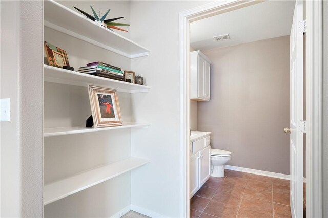 139 Heron Oaks St, Rockport, TX 78382 - bathroom featuring vanity, toilet, baseboards, ceiling fan, and tile patterned flooring