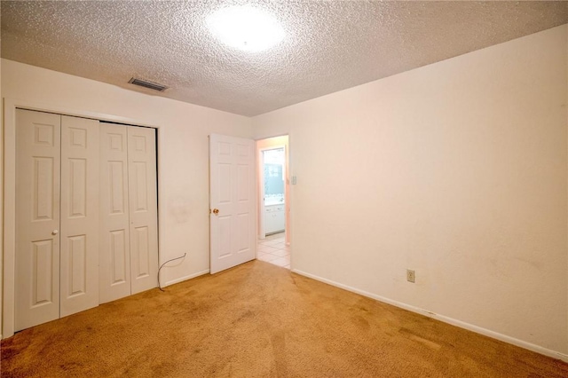 1601 Spicewood Dr, Corpus Christi, TX 78412 - unfurnished bedroom with carpet flooring, a closet, and a textured ceiling