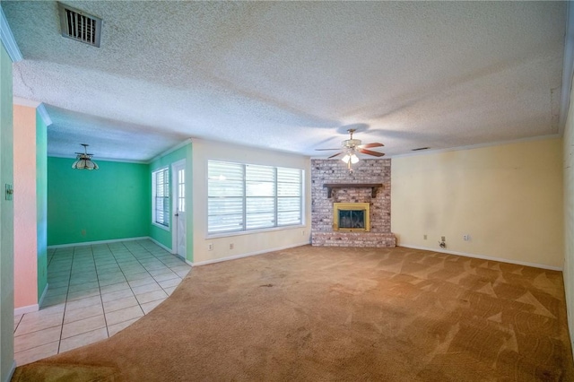 1601 Spicewood Dr, Corpus Christi, TX 78412 - unfurnished living room featuring ceiling fan, carpet flooring, crown molding, tile patterned floors, and a fireplace