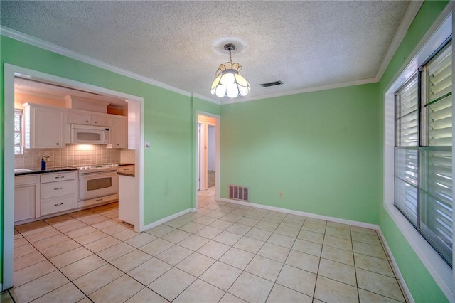 1601 Spicewood Dr, Corpus Christi, TX 78412 - kitchen with white appliances, a chandelier, white cabinets, light tile patterned floors, and a textured ceiling