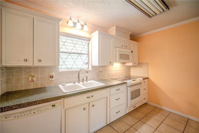 1601 Spicewood Dr, Corpus Christi, TX 78412 - kitchen featuring white appliances, tasteful backsplash, light tile patterned floors, crown molding, and white cabinets