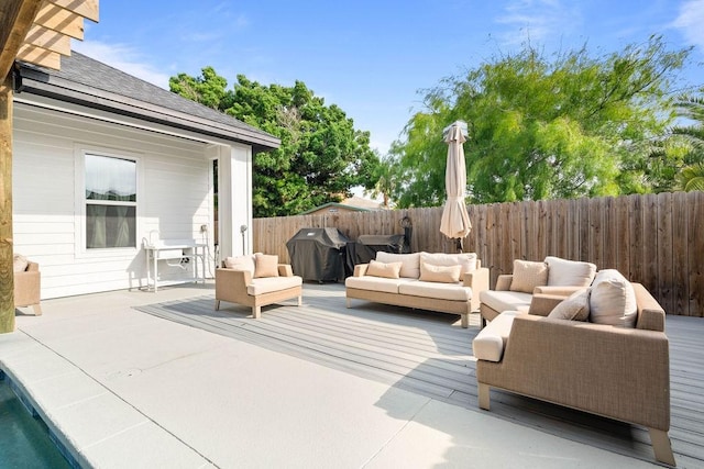 wooden deck with a patio, a fenced backyard, an outdoor hangout area, and area for grilling