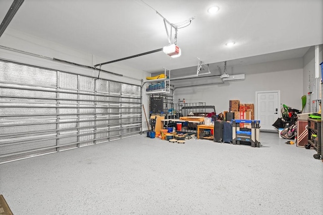 garage featuring recessed lighting and a garage door opener