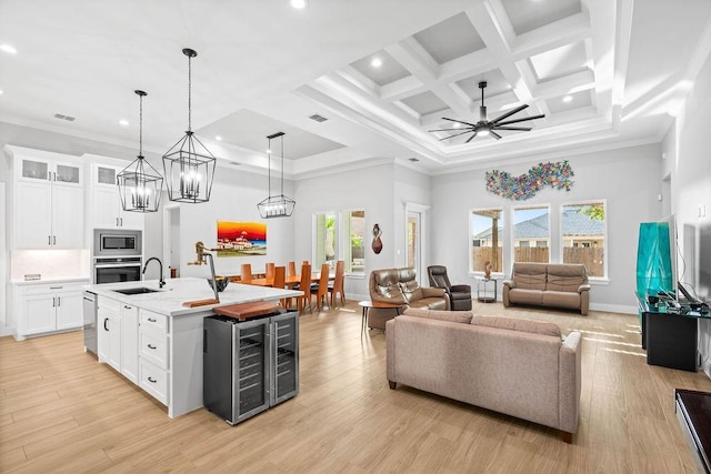 living room featuring crown molding, a high ceiling, beverage cooler, recessed lighting, and coffered ceiling