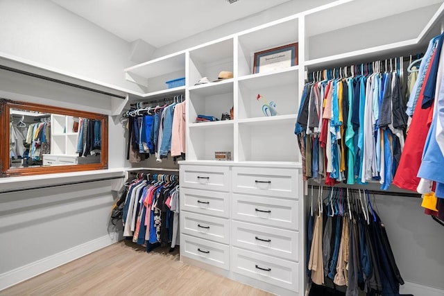 spacious closet featuring light wood-style flooring