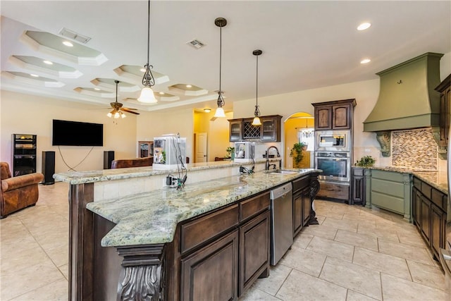 kitchen with a sink, arched walkways, visible vents, and stainless steel appliances