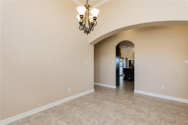 unfurnished room with an inviting chandelier, crown molding, baseboards, and arched walkways