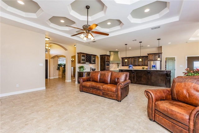 living area with visible vents, recessed lighting, arched walkways, coffered ceiling, and a ceiling fan