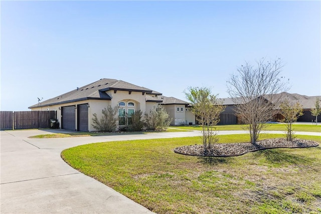 mediterranean / spanish house featuring curved driveway, fence, a front lawn, and stucco siding