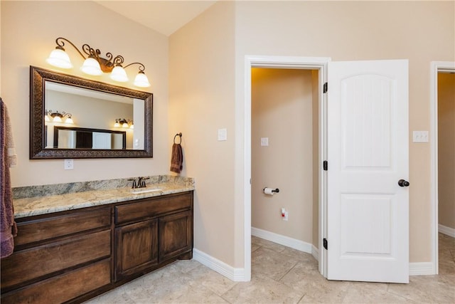 bathroom with tile patterned floors, vanity, and baseboards