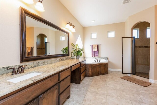 full bathroom with visible vents, baseboards, a tile shower, a bath, and vanity