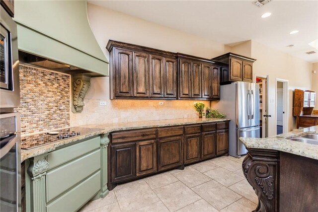 kitchen featuring custom exhaust hood, dark brown cabinetry, stainless steel appliances, and tasteful backsplash