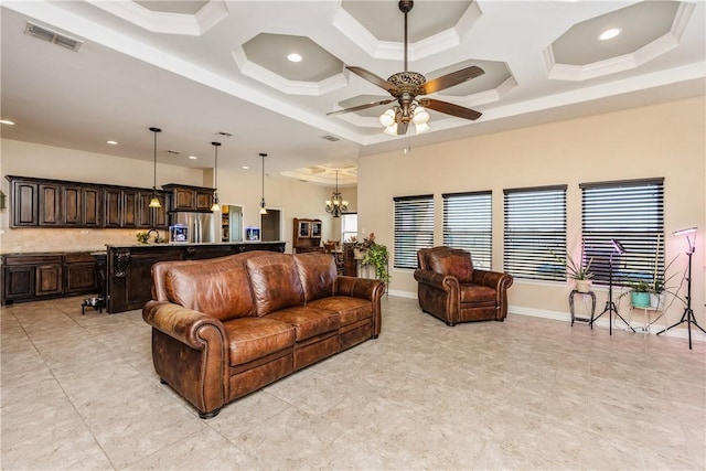 living area with a wealth of natural light, visible vents, ceiling fan with notable chandelier, and coffered ceiling