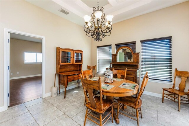 dining room featuring light tile patterned floors, baseboards, visible vents, coffered ceiling, and a notable chandelier