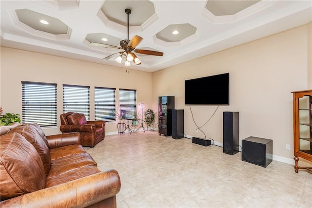 living room with coffered ceiling, baseboards, a high ceiling, and ceiling fan