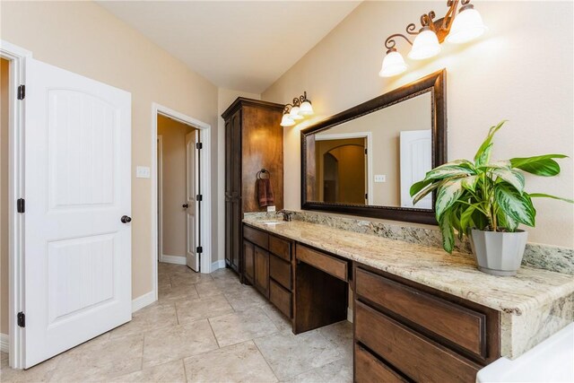 bathroom with vanity and baseboards