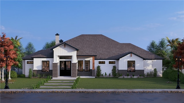 view of front of home featuring a shingled roof, a chimney, and a front yard