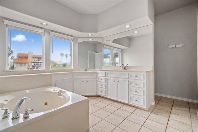 bathroom with a sink, a jetted tub, tile patterned flooring, and double vanity
