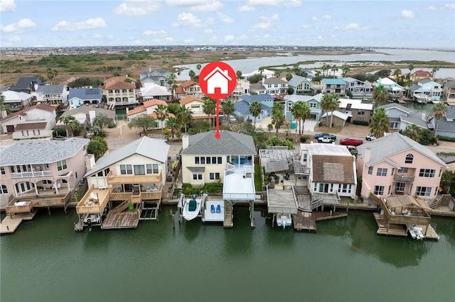 drone / aerial view featuring a water view and a residential view